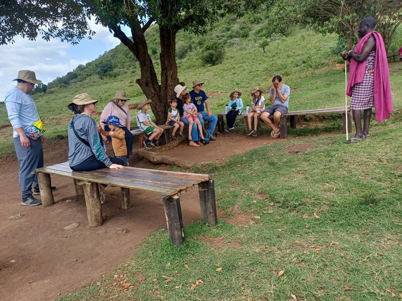 A Mzingo guide talking with a group of guests during a safari