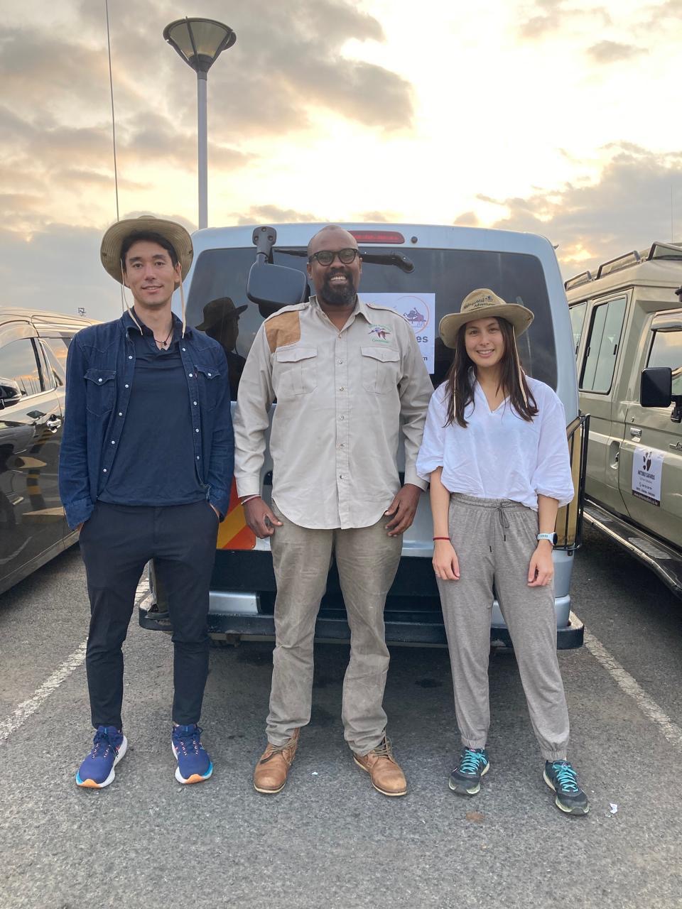 Two guests with their guide at the end of a day on safari