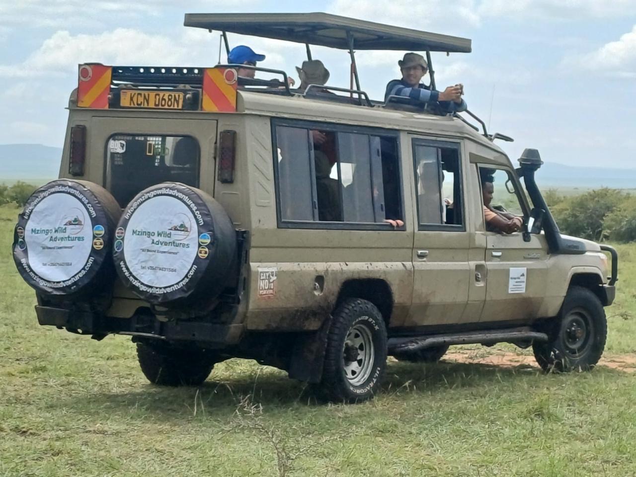 Guests game-viewing from the roof of a Mzingo safari vehicle