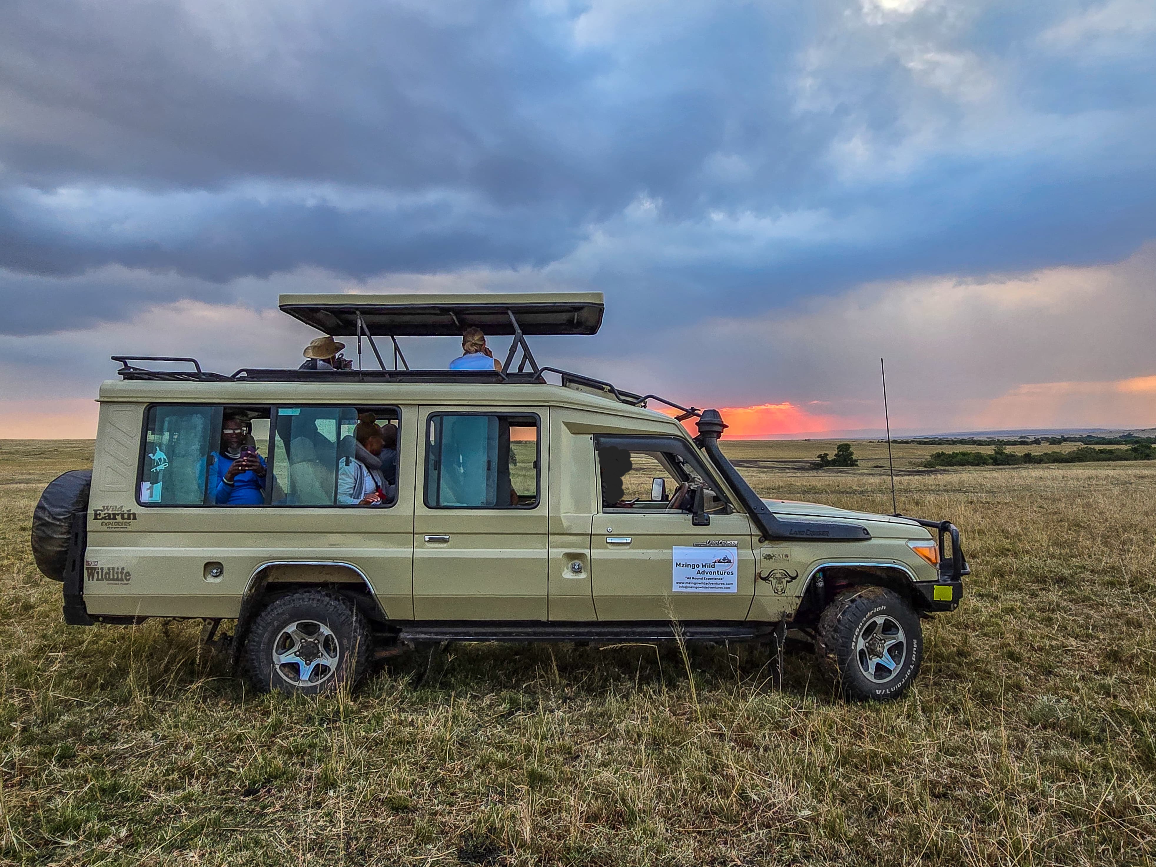 Safari vehicle at sunset in the Masai Mara